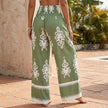 Back view of FJØRNA women's cotton summer trousers with drawstring waist and relaxed fit, showcasing the casual, comfortable design.