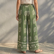 Back view of FJØRNA women's summer cotton wide-leg trousers showing relaxed fit and lightweight fabric.