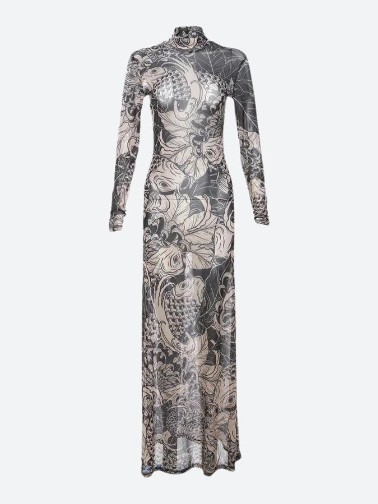 White Baddie Tattoo Maxi Dress by FJØRNA, featuring a fitted silhouette and stylish tattoo-inspired print, worn by a model.