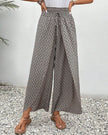 Beige lightweight summer women's trousers by FJØRNA, wide-leg breathable flowy pants with relaxed fit.