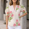Beige floral summer blouse for women with V-neck, puff sleeves, and high waist from FJØRNA, stylish and lightweight top.