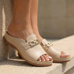 Beige FJØRNA orthopedic slip-on sandals with buckle embellishment, featuring supportive design and open-toe style.