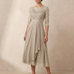 Beige embroidered FJØRNA A-line midi dress with sheer sleeves and side pockets, stylish and elegant for special occasions.