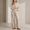 Beige women's summer two-piece co-ord set with wide-leg pants and matching top by FJØRNA.