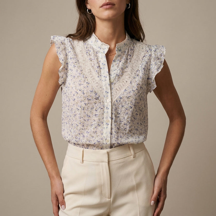 Beige floral sleeveless summer blouse for women by FJØRNA, featuring lightweight fabric and feminine design.