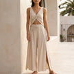 Beige women's summer two-piece set by FJØRNA featuring a ruched V-neck top and matching shorts.