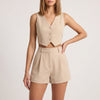 Beige women's two-piece co-ord set with pleated V-neck top and matching skirt by FJØRNA, stylish and elegant for casual or dressy wear.