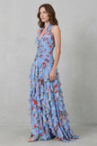 FJØRNA elegant floral maxi dress for women with halter neck and flowy silhouette, featuring romantic cascade design.