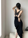 Black butterfly back midi dress from FJØRNA featuring a sleek silhouette and elegant design, shown on a model.