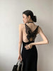 Black Butterfly Back Midi Dress by FJØRNA, featuring a sleek black dress with fluttery butterfly back detail and midi length.