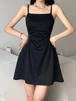 Black sleeveless mini dress by FJØRNA, shown in mauv studio, featuring a fitted silhouette and stylish sleeveless design.