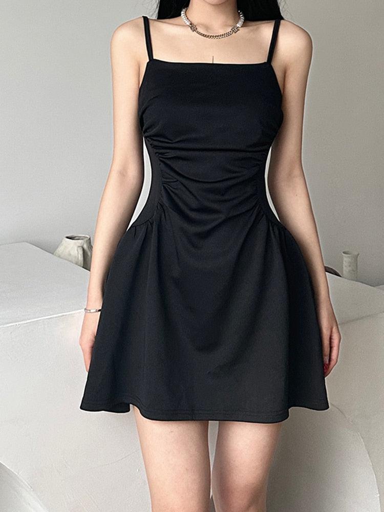 FJØRNA black sleeveless mini dress, casual style, fitted silhouette, and sleeveless design, shown on a model.