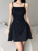 Black sleeveless mini dress by FJØRNA, shown in a stylish fit on a model; perfect for casual or evening wear.