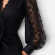 Women's black lace midi dress with elegant slim fit and lace sleeves, perfect for wedding guest or formal occasions by FJØRNA.