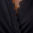 Women's black midi dress with lace sleeves by FJØRNA, featuring a slim fit and elegant design perfect for special occasions.