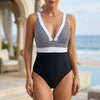 Black and white women's summer one-piece swimsuit by FJØRNA featuring a V-neck and backless design, perfect for beachwear.