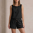 FJØRNA elegant black two-piece women's co-ord set with button-front top and matching pants on a model.