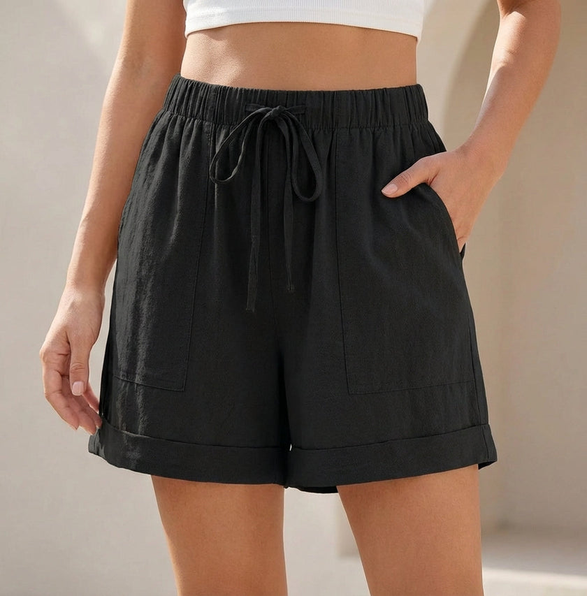 Black women's linen summer shorts with pockets and drawstring, by FJØRNA, featuring a casual and comfortable fit.