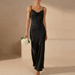 Black satin fitted cowl neck maxi dress with spaghetti straps by FJØRNA, perfect for elegant evening occasions.