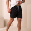 FJØRNA men's black quick-dry relaxed-fit swim shorts with side pockets and slit hem, casual and comfortable for beach or pool.