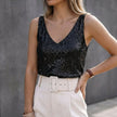 Black FJØRNA sequin sleeveless women's top with V-neck and all-over embellishments, featuring shiny, reflective sequins and a fitted silhouette.