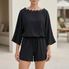 Black FJØRNA two-piece set with eyelet lace trim, relaxed fit, featuring a stylish top and matching pants in a casual silhouette.