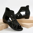 Black FJØRNA orthopedic heeled wedge sandals with cut-out design for women, stylish and supportive footwear.