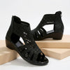 Black FJØRNA orthopedic heeled wedge sandals with cut-out design for women, stylish and supportive footwear.