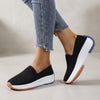 Black FJØRNA women's orthopedic sneakers with knit upper and arch support for comfortable, supportive footwear.