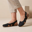 Black FJØRNA orthopedic closed-toe slingback sandals for women, featuring supportive design and comfortable fit.
