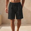 FJØRNA men's black quick-dry above-the-knee swim shorts with relaxed fit and drawstring waist, perfect for beach or pool.