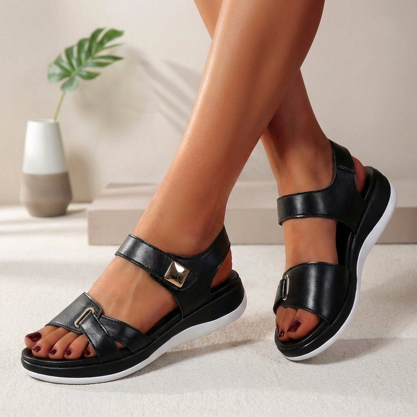 Black FJØRNA orthopedic platform open toe sandals for women with cushioned footbed and adjustable straps.
