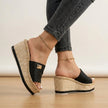 Black FJØRNA women's orthopedic espadrille wedges with adjustable straps and supportive sole.
