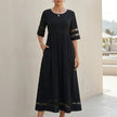 Black FJØRNA A-line maxi dress with mesh panels and side pockets, perfect for elegant and comfortable women's wear.