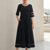 Black FJØRNA A-line maxi dress with mesh panels and side pockets, perfect for elegant and comfortable women's wear.