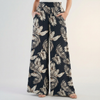Black women’s summer trousers by FJØRNA featuring cotton fabric and ruched details for a stylish, comfortable look.