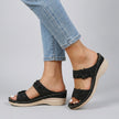 Black FJØRNA women's orthopedic heeled sandals with wedge heel and adjustable strap, stylish and supportive footwear.
