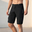 Men's black outdoor performance shorts by FJØRNA with zippered pockets, designed for comfort and active wear.