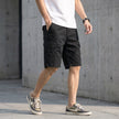 Men's black casual cargo shorts with distinctive stitch detail by FJØRNA, showing the front view with pockets and stitching accents.