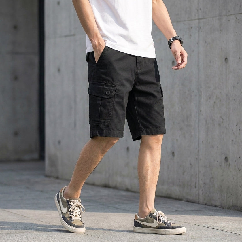 Men's black casual cargo shorts with distinctive stitch detail by FJØRNA, showing the front view with pockets and stitching accents.
