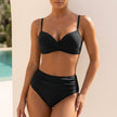 Black FJØRNA ruched twist-front bikini set for women featuring tummy control and stylish design, perfect for beach and pool.
