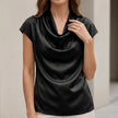 Black satin summer blouse for women with a cowl neck and short sleeves, styled by FJØRNA.