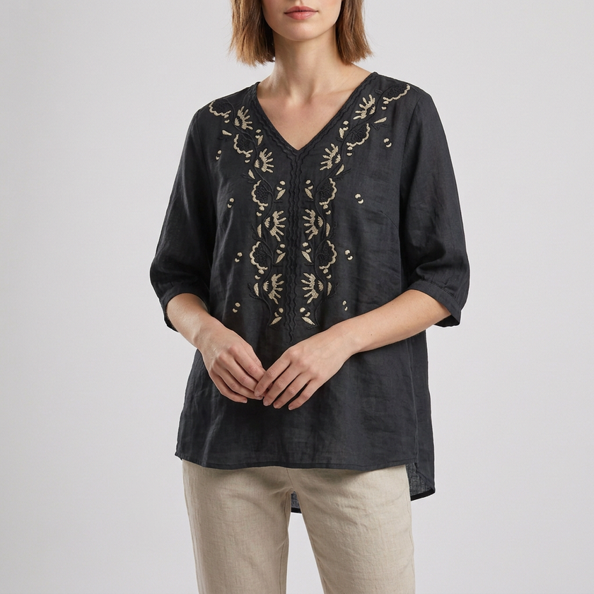 Black floral V-neck linen summer blouse for women by FJØRNA, featuring a slit design and lightweight, breathable fabric.