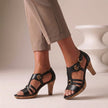 Black FJØRNA orthopedic T-strap heeled sandals for women with open toes and ankle straps, stylish and supportive footwear.