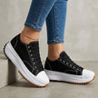 Black FJØRNA women's orthopedic sneakers with lace-up design, featuring supportive soles and comfortable fit for everyday wear.