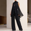 Black chiffon pleated two-piece women's co-ord set by FJØRNA, featuring a flowy top and matching wide-leg pants.