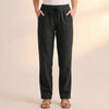 Black women's summer linen trousers with pockets by FJØRNA, featuring a relaxed fit and casual style.