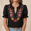 Black floral summer blouse for women with puff sleeves and ruffle details by FJØRNA, perfect for warm weather and casual wear.