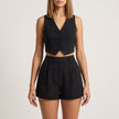 FJØRNA elegant black two-piece women’s co-ord set with pleated V-neck top and matching pants, stylish and sophisticated ensemble.