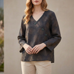 Black women's summer blouse by FJØRNA featuring a V-neck, linen fabric, and slit detailing, perfect for warm-weather styles.
